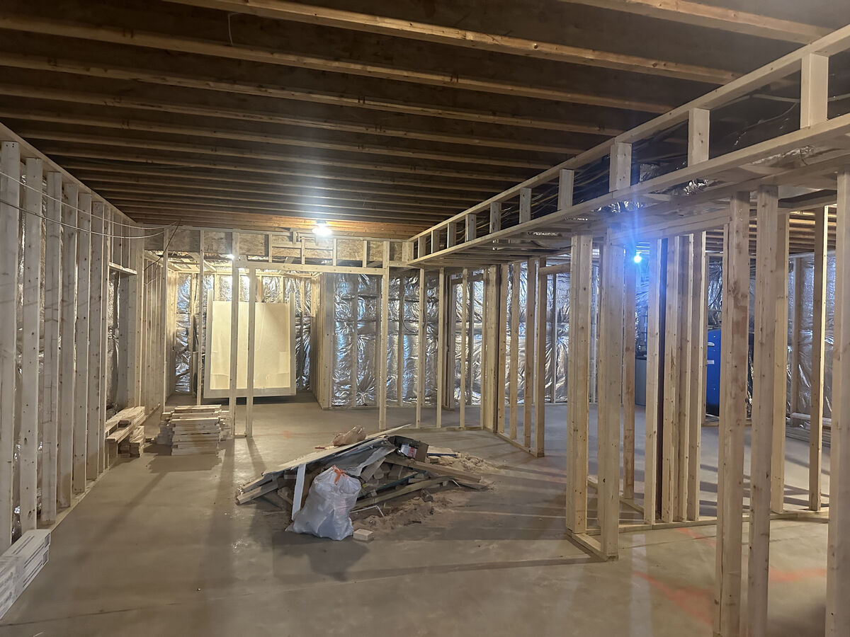 Unfinished basement framing before MB Builds renovation