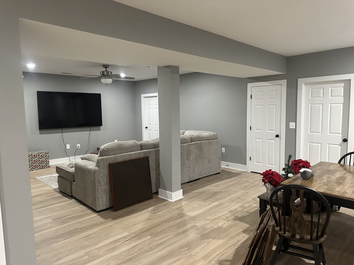 Finished basement entertainment room with TV wall